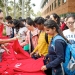 Students selecting free red ANU t-shirts at the 2018 Welcome Party